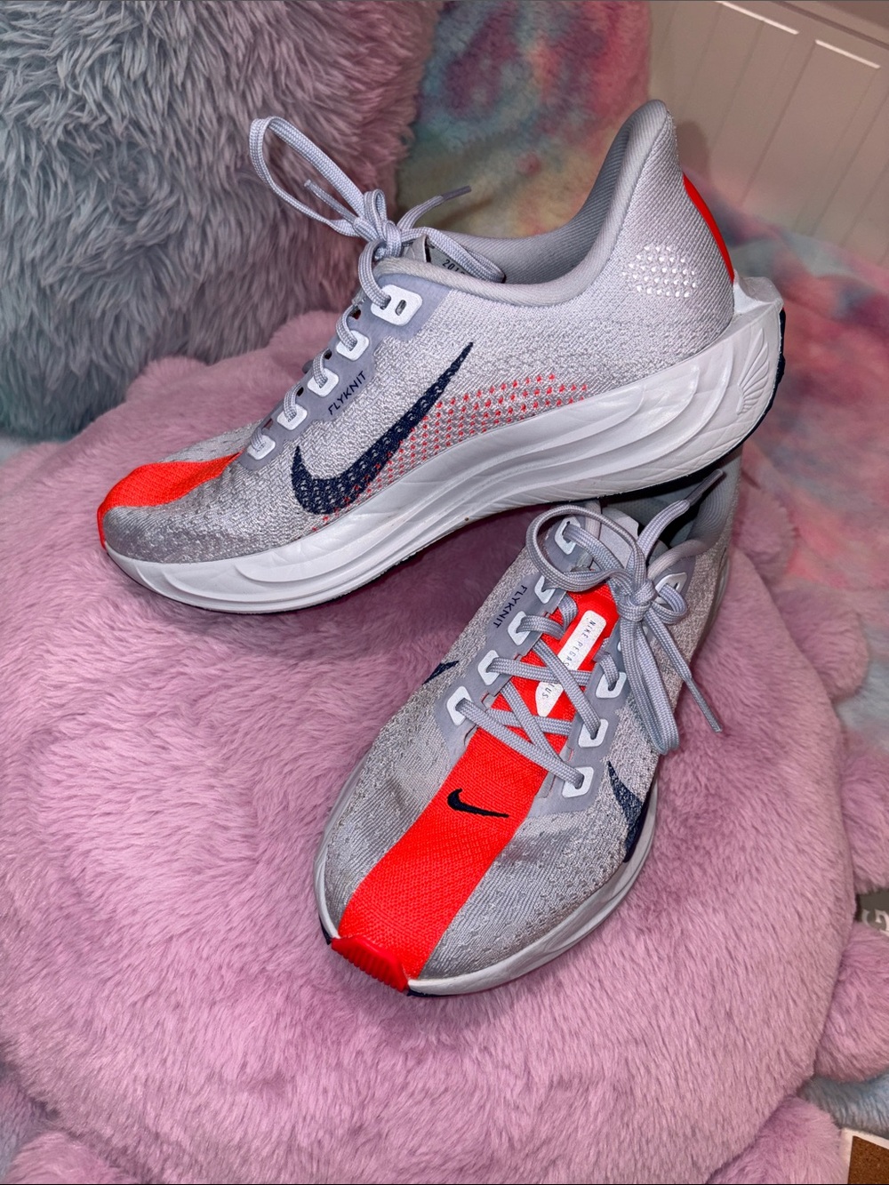 Nike women’s Grey and Bright Orange Flyknit Trainer with Navy Swoosh